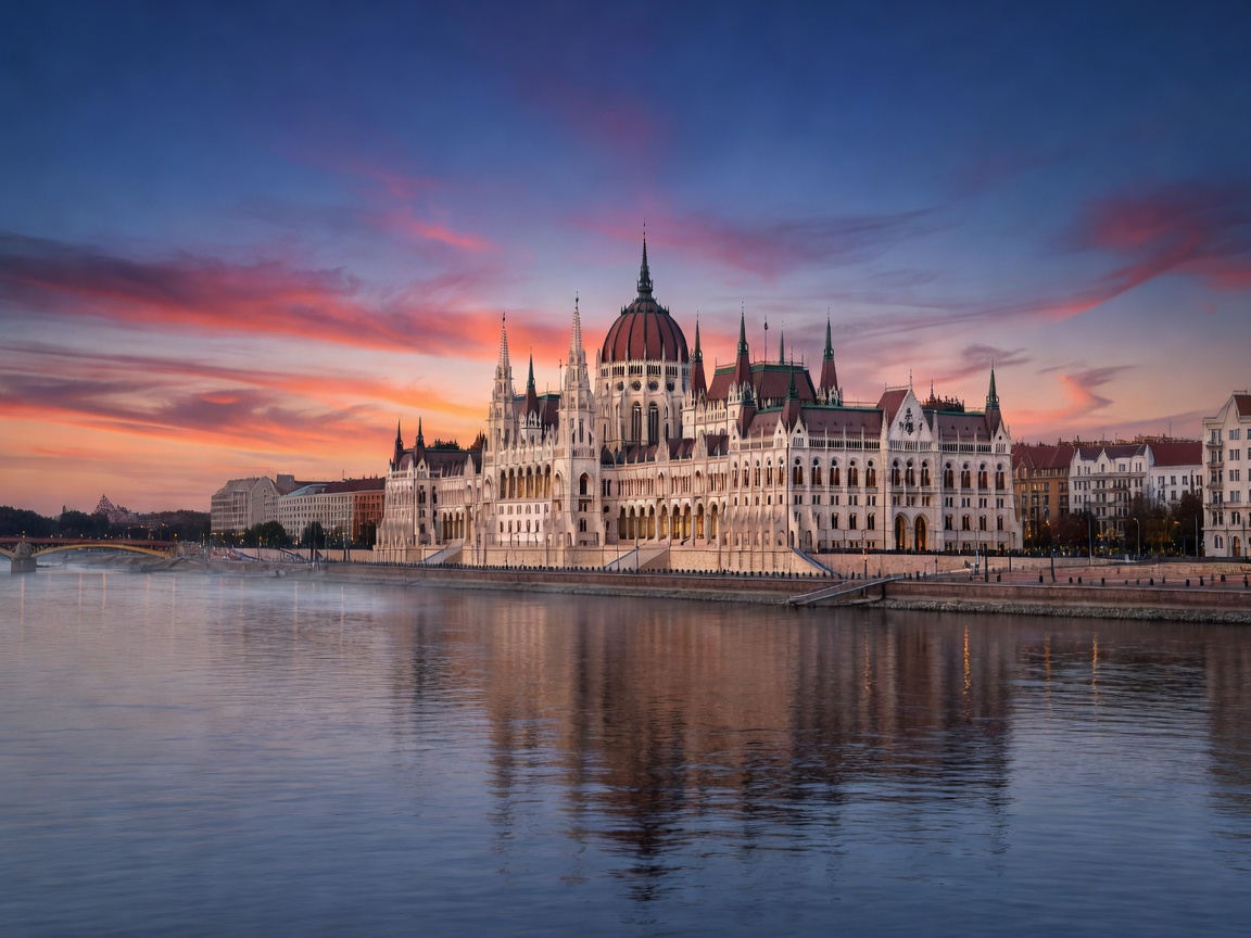 Budapest Parliament along the Danube river at dusk